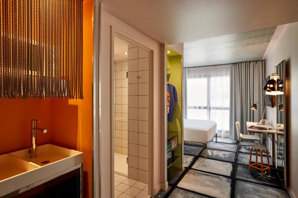 a bathroom with a sink and a shower and a room at Mama Shelter Lyon in Lyon