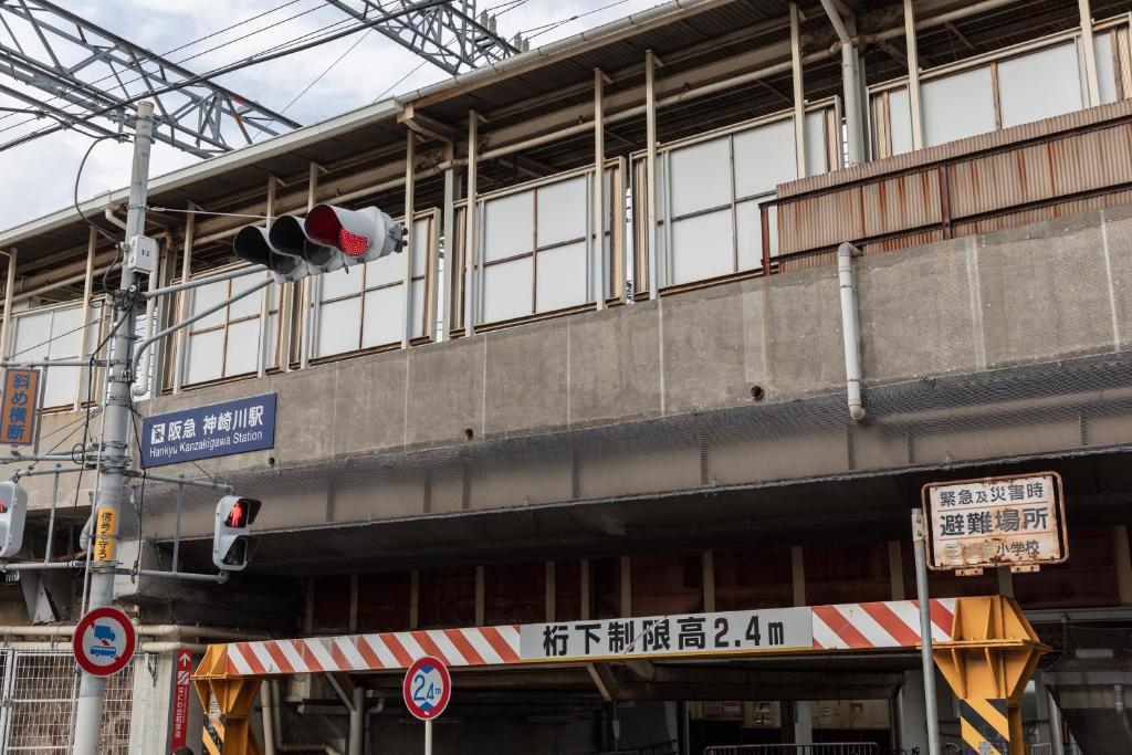 a building with a traffic light in front of it at Osaka Kanzakigawa Royal駅徒步1分 "private house 3 bed rooms "一棟貸し宿 in Osaka