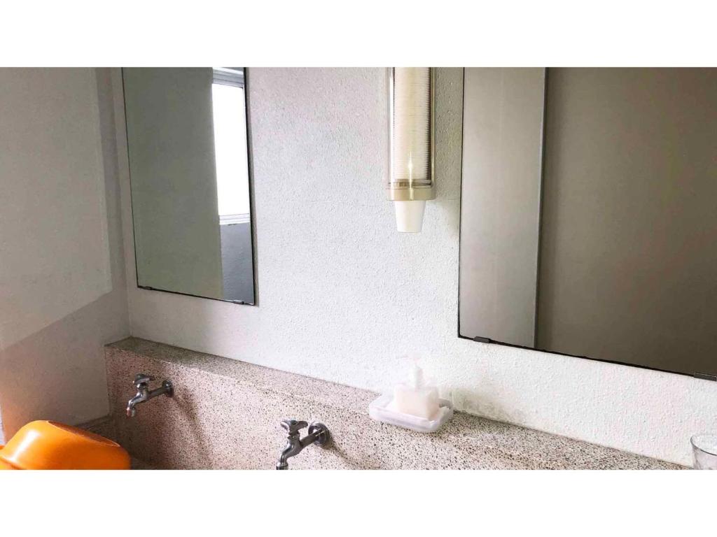a bathroom with a sink and a mirror at Kagetsu Ryokan - Vacation STAY 04882v in Shizuoka