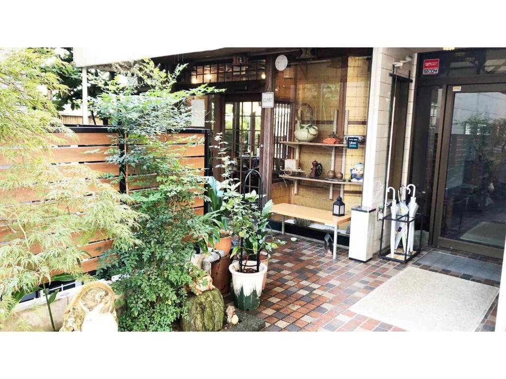 a building with a bunch of plants in front of it at Kagetsu Ryokan - Vacation STAY 04882v in Shizuoka