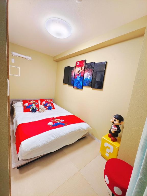 a bedroom with a large bed with a red blanket at 新宿区 新宿御苑前駅から歩いて5分 コンビニ1分 アパート全体を貸し出す民宿 in Tokyo