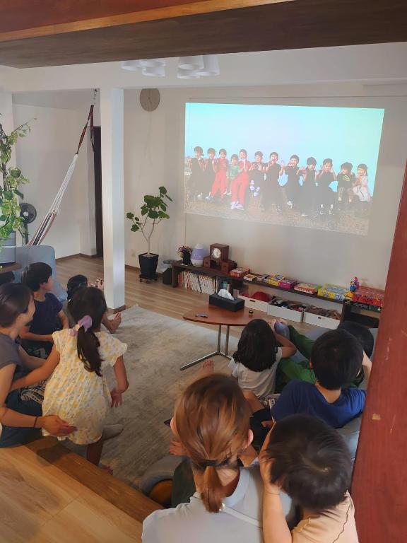 a group of children sitting in a room watching a screen at 風早邸海音 kazahayatei mion in Hōjō