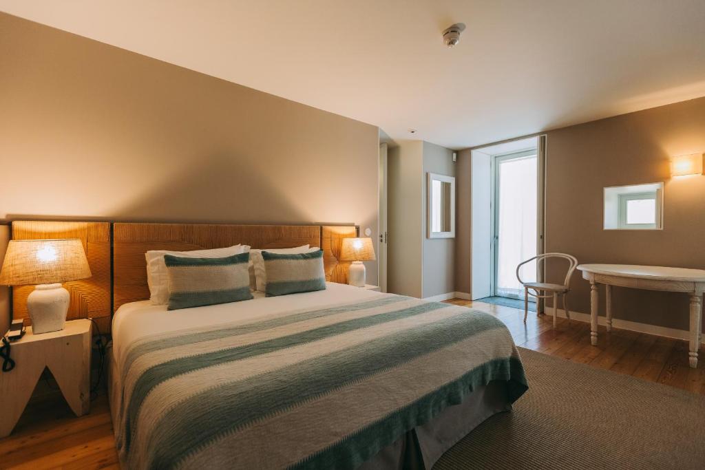 Uma cama ou camas num quarto em Ventozelo Hotel & Quinta