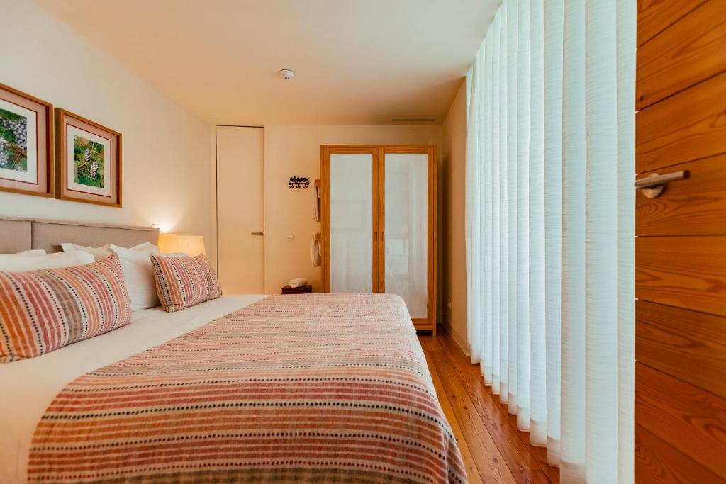 Uma cama ou camas num quarto em Ventozelo Hotel & Quinta