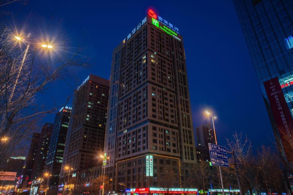 a tall building in a city at night at Holiday Inn Express Shenyang Golden Corridor by IHG in Shenyang