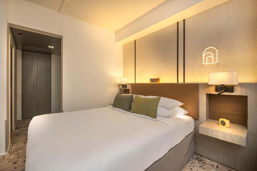 a bedroom with a large white bed and cabinets at FirstName Toulouse by Hyatt in Toulouse