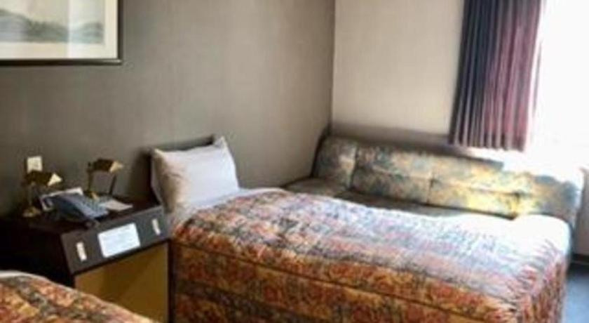 a hotel room with a bed and a desk at Shizuoka UI Hotel in Shizuoka