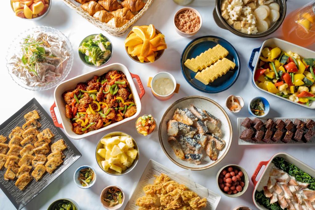 a table with many different dishes of food on it at Premier Hotel Cabin Shinjuku in Tokyo