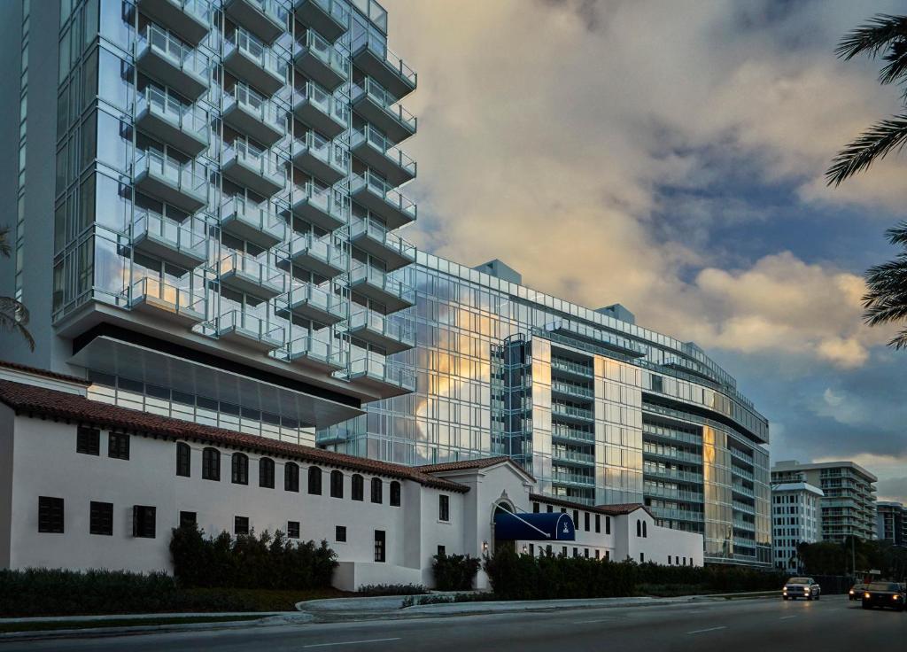 a large glass building with a street in front of it at Four Seasons Hotel at The Surf Club in Miami Beach
