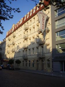 a building with a sign on the side of it at Hotel Hetman in Warsaw