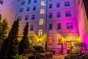 a building with pink and purple lights on it at Myer's Hotel Berlin in Berlin