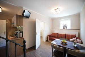 a living room with a table and a couch at Guest house Villa Fritz in Potsdam