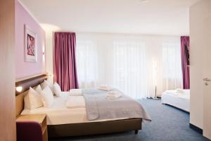 a hotel room with a bed with red curtains at Hotel Nikolai Residence in Berlin
