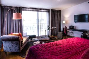 a bedroom with a red bed and a large window at Best Western Plus Time Hotel in Stockholm