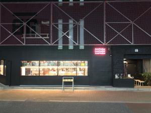 a store front with a sign in front of it at Book Tea Bed SHINJUKU-GYOEN in Tokyo