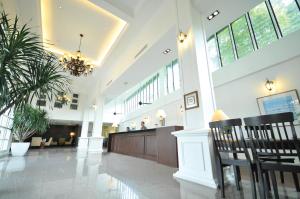 a large lobby with a waiting area and a chandelier at The Sterling Boutique Hotel Melaka in Malacca