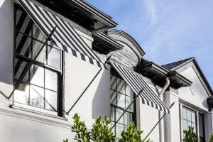 a house with a black and white striped awning at The Prospect Hollywood in Los Angeles +5 photos