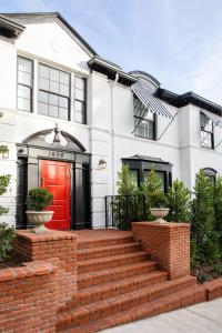 a house with a red door and brick stairs at The Prospect Hollywood in Los Angeles