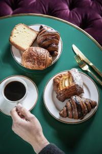 a table with two plates of pastries and a cup of coffee at The Prospect Hollywood in Los Angeles