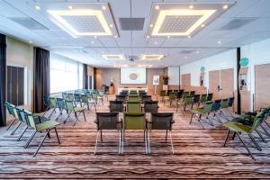 a conference room with chairs and a podium in the middle at Novotel Rotterdam - Schiedam in Schiedam +37 photos