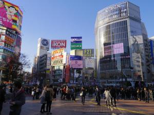 a crowd of people crossing a street in a busy city at ☆Cozy Japanese style room☆ in Tokyo
