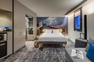 a hotel room with a bed and a couch at Novotel Suites Berlin City Potsdamer Platz in Berlin +37 photos