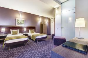 a hotel room with two beds and a table at Hotel Metropol in Warsaw +36 photos