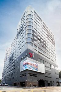 a tall building with a vita sign on it at The Salisbury - YMCA of Hong Kong in Hong Kong