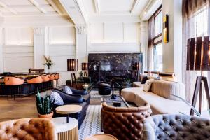 a living room with couches and a fireplace at Surety Hotel in Des Moines