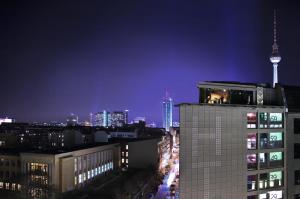 a view of a city at night with the tv tower at Casa Camper Berlin in Berlin