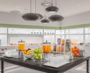 een tafel met fruit en drankjes in de keuken bij TITANIC Comfort Kurfürstendamm in Berlijn