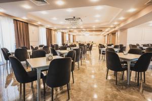 a room with tables and chairs in a room at Hotel Residence Plaza in Tbilisi City +37 photos