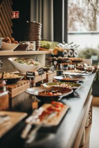 a buffet line with many plates of food on it at Air Hotel in Warsaw