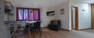 a kitchen and dining room with a table and chairs at Chalet 5 Laghi / LuxApt / Town Centre in Madonna di Campiglio +19 photos