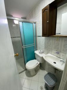 a bathroom with a toilet and a shower and a sink at Hotel Gran Imperio in Medellín