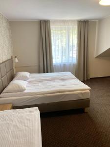 a bedroom with a large bed and a window at GRACJA in Warszawa