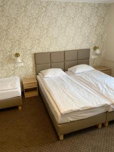 a bedroom with a large bed and a wall at GRACJA in Warszawa +11 photos