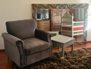 a living room with a chair and a table at Residenz Villa Kult in Berlin