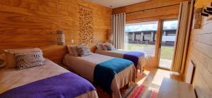 Ένα ή περισσότερα κρεβάτια σε δωμάτιο στο Rumbo Sur Hotel