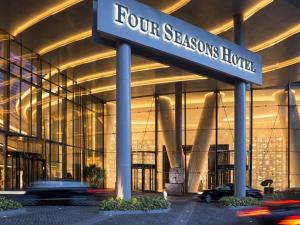 a four seasons hotel sign in front of a building at Four Seasons Hotel Guangzhou in Guangzhou