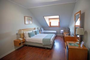 Una cama o camas en una habitación de Gran Hotel Vicente Costanera