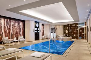 a lobby with a blue pool in the middle of a room at The Ritz-Carlton, Berlin in Berlin