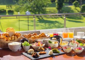 a table topped with baskets of food and drinks at Hotel Laforet Shuzenji in Izu