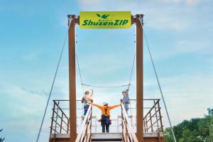 a group of people standing on a bridge at Hotel Laforet Shuzenji in Izu