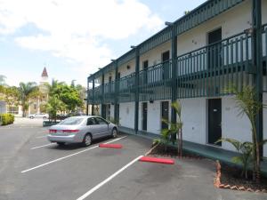 a car parked in a parking lot next to a building at Americas Best Value Inn Loma Lodge in San Diego