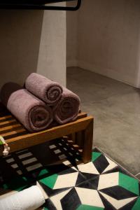 a pile of towels sitting on a wooden table at Casa Antonieta in Oaxaca City +37 photos