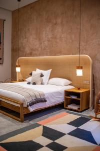 a bedroom with a large bed and a table at Casa Antonieta in Oaxaca City