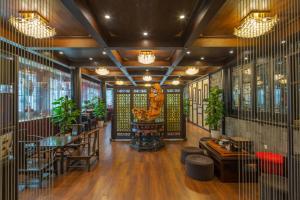 a restaurant with a table and chairs and plants at Buddha Zen Hotel in Chengdu