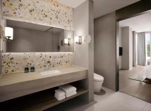 a bathroom with a sink and a mirror at The Westin Resort Guam in Tumon