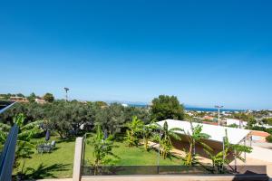 a view of the garden from the balcony of a resort at Airscape Hotel Free Shuttle From Athen's Airport in Artemida